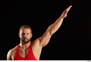 Dave  1 arm dressed flexing front view red tank…